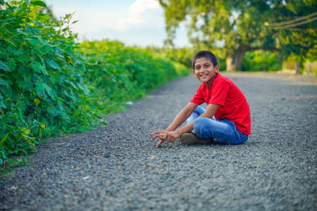 indian child playing with stoneの写真素材