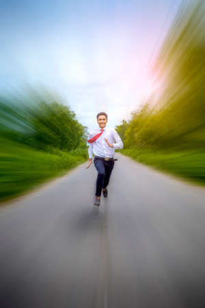 Young asian / Indian boy running on the roadの写真素材