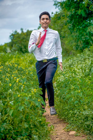 Young asian / Indian boy running on the road