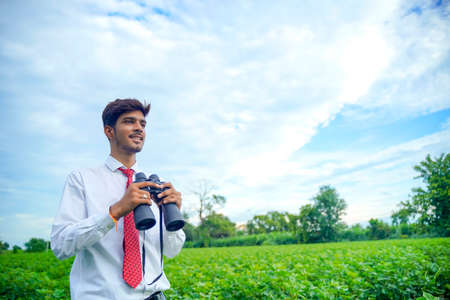 Indian man enjoys in nature with binocularsの写真素材