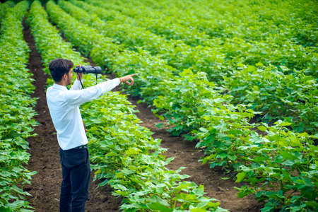 Indian man enjoys in nature with binocularsの写真素材