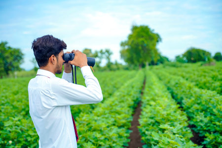 Indian man enjoys in nature with binoculars