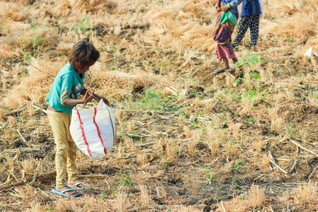 Jalgaon, India - March 17, 2020: Poor indian children playing at field , rural life of India