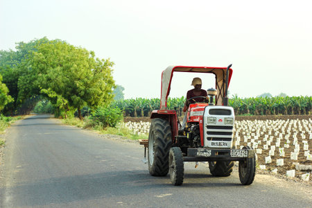 Jalgaon, India - April 14, 2020: Indian farmer with tractor on road