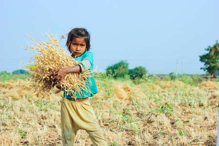 Jalgaon, India - March 17, 2020: Poor indian children playing at field , rural life of Indiaのeditorial素材