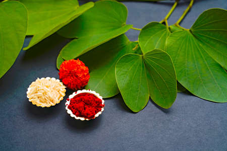 Indian festival dussehra , green leaf, rice and flowersの写真素材