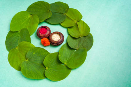 Indian festival dussehra , green leaf, rice and flowersの写真素材