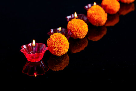 Indian festival diwali ,marigold flower and Colorful lamps of oil on black background