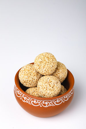 Indian sweet for traditional festival makar sankranti :Rajgira laddu made from Amaranth seed in Bowl on white backgroundの写真素材