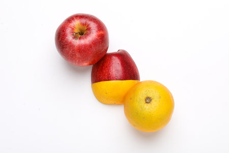 Stack of fresh fruits citrus slices, apple, orange or lemon. Colorful healthy fitness creative fun food concept. Mixed citrus fruit, apple isolated on white backgroundの写真素材