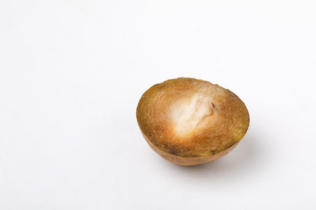 fresh whole and half of sapodilla fruit isolated on white backgroundの写真素材