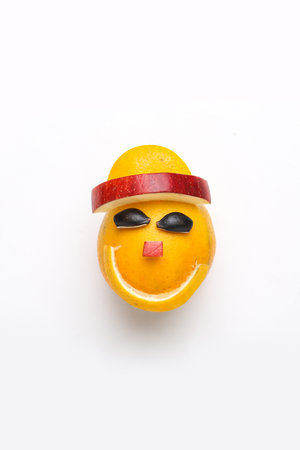 Orange or sweet lemon mosambi fruit cut in happy smile face shape on white backgroundの写真素材