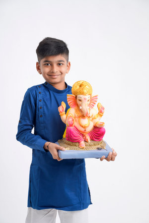 Indian little boy with lord ganesha , Celebrating Ganesh Festival