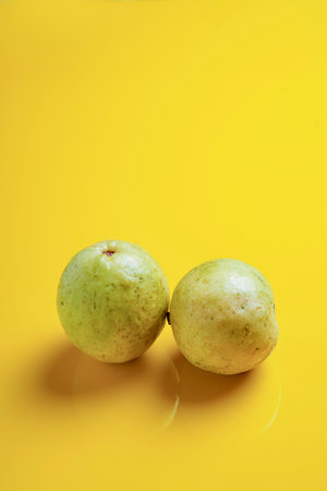 Guava or Psidium guajava Linn , fruits on yellow background.の写真素材