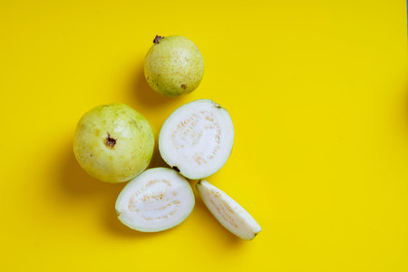 Guava or Psidium guajava Linn , fruits on yellow background.の写真素材