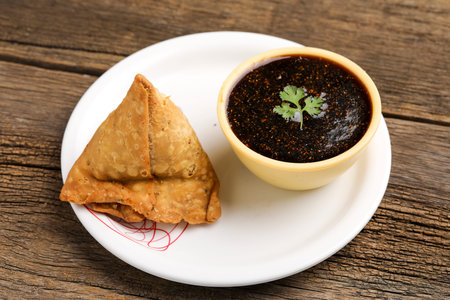 Kachori is a spicy snack from India also spelled as kachauri and kachodi. Served with tomato...