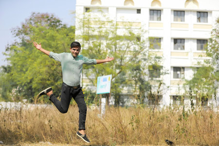 Young indian man Jump in air after achieving success.