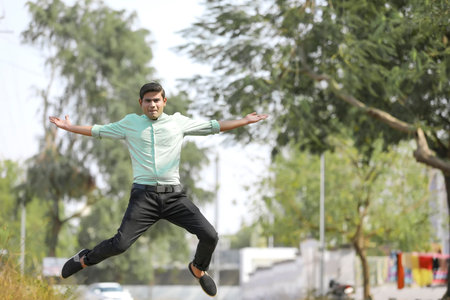 Young indian man Jump in air after achieving success.の写真素材