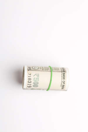 A stack of five hundred rupee notes (Indian currency) isolated on a white background.の写真素材
