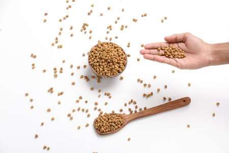 Dried chickpeas in bowl isolated on white background.