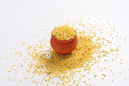 yellow moong mung dal lentil pulse bean in a bowl on white background.