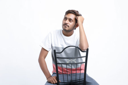 Young handsome indian college student giving expression on white background.