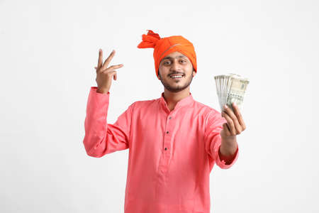Young Indian farmer posing with currency on white background.の写真素材