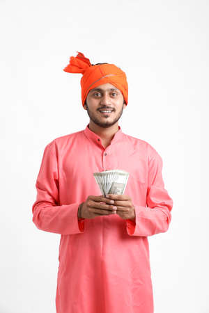 Young Indian farmer posing with currency on white background.の写真素材