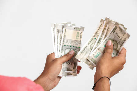 Indian man counting newly launched indian five hundred rupees. Money counting background business concept on white backgroundの写真素材