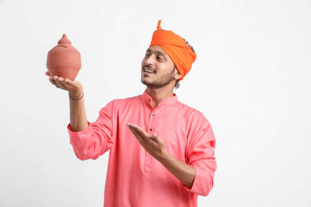 Indian Farmer holding piggy bank on white backgroundの写真素材