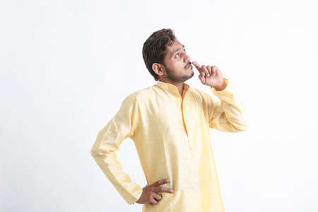 Indian man showing thinking expression on white backgroundの写真素材