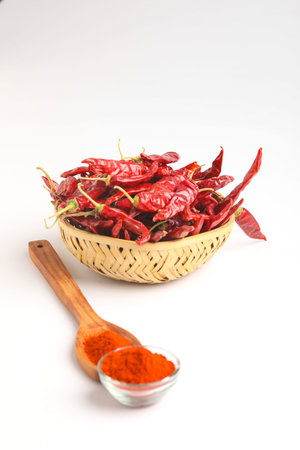 Dried red chilli wooden bowl on white background.