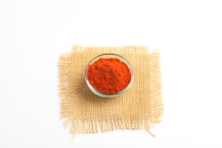 Red chilli powder in glass bowl on white background.の写真素材