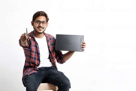 Young indian Professional designer showing graphic tablet with digital pen.の写真素材