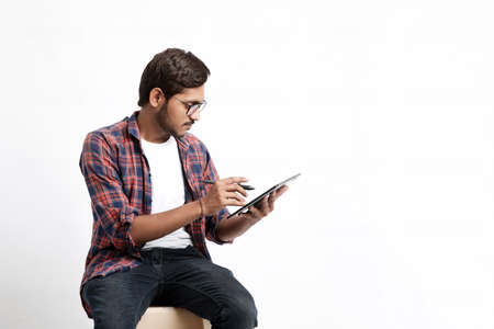 Indian Professional designer using graphic tablet connected to smartphone with digital pen.の写真素材
