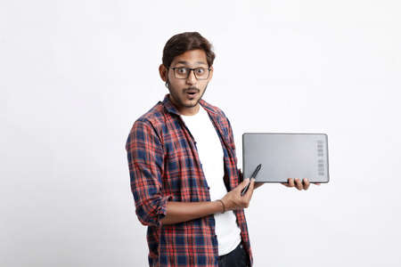 Young indian Professional designer showing graphic tablet with digital pen.の写真素材