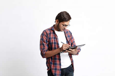 Indian Professional designer using graphic tablet connected to smartphone with digital pen.の写真素材