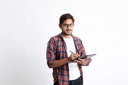 Indian Professional designer using graphic tablet connected to smartphone with digital pen.の写真素材