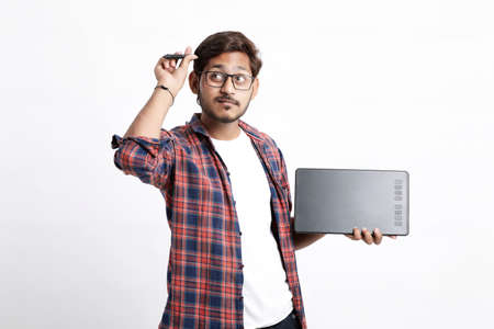 Young indian Professional designer showing graphic tablet with digital pen.の写真素材