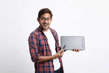 Young indian Professional designer showing graphic tablet with digital pen.の写真素材