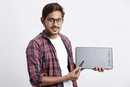 Young indian Professional designer showing graphic tablet with digital pen.の写真素材