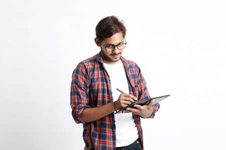 Indian Professional designer using graphic tablet connected to smartphone with digital pen.の写真素材