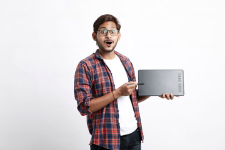 Young indian Professional designer showing graphic tablet with digital pen.の写真素材