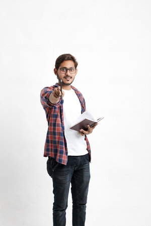 Education concept : Indian college student holding bag and showing note book on white background.