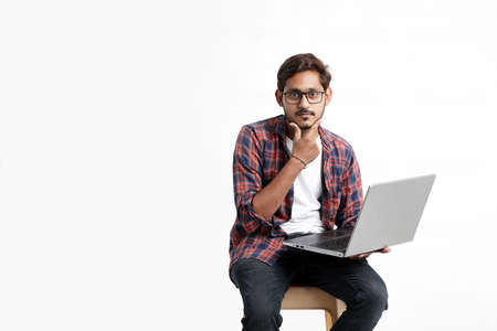 Young indian man thinking some idea when working on laptop.の写真素材