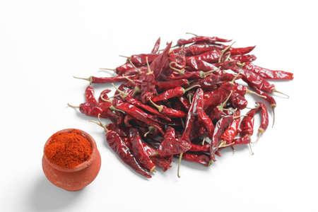 Red chilli powder with dried red chillies. in earthen bowl.の写真素材