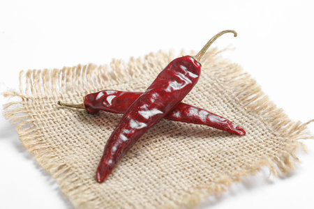 Dried red chilli on white background.