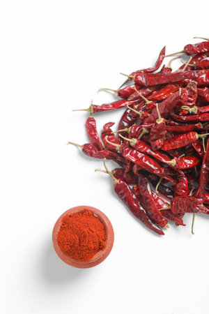 Red chilli powder with dried red chillies. in earthen bowl.の写真素材