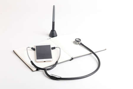 Smartphone and stethoscope on whiteの写真素材