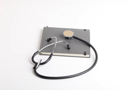 Black stethoscope lying on the diary, medicine.の写真素材
